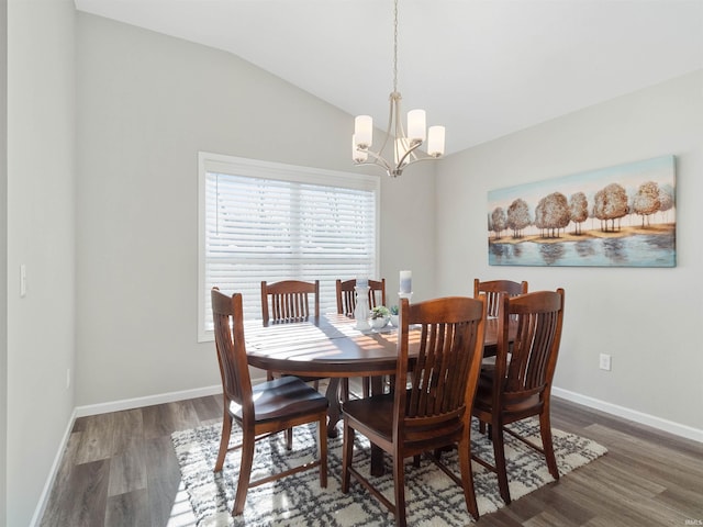 dining area with vaulted ceiling, dark hardwood / wood-style floors, and an inviting chandelier