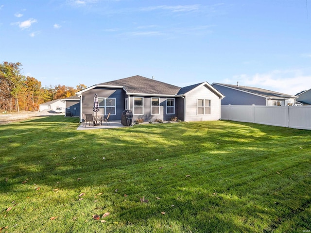 back of house featuring a yard and a patio