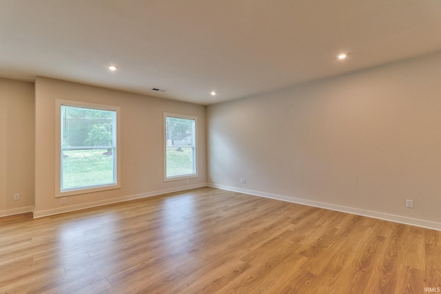 spare room featuring light wood-type flooring