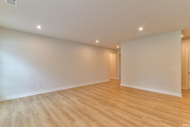 empty room with light hardwood / wood-style flooring