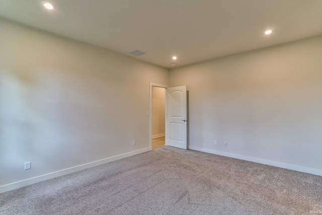 empty room with light colored carpet