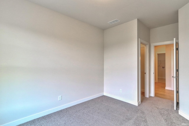 empty room featuring light carpet