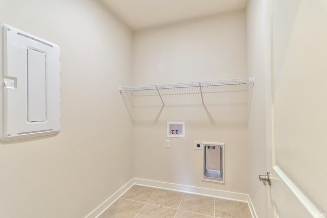 laundry room featuring washer hookup, light tile patterned floors, and electric dryer hookup