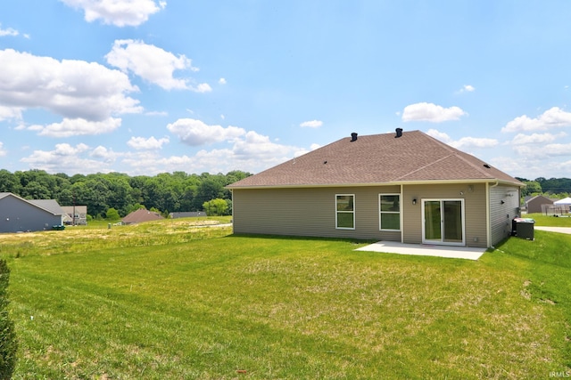back of house with cooling unit, a yard, and a patio