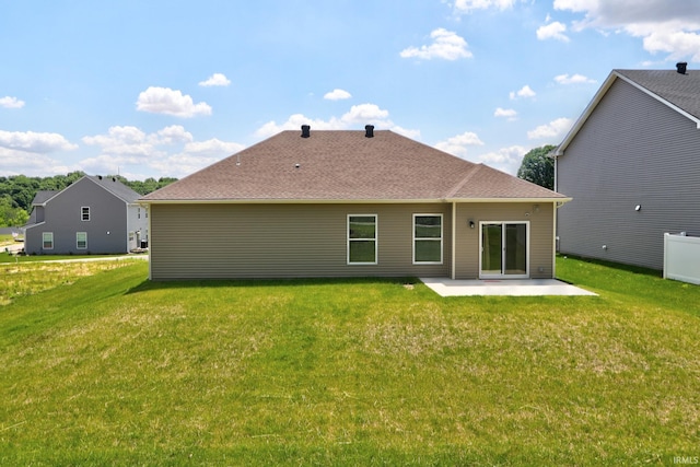 back of house featuring a lawn and a patio area