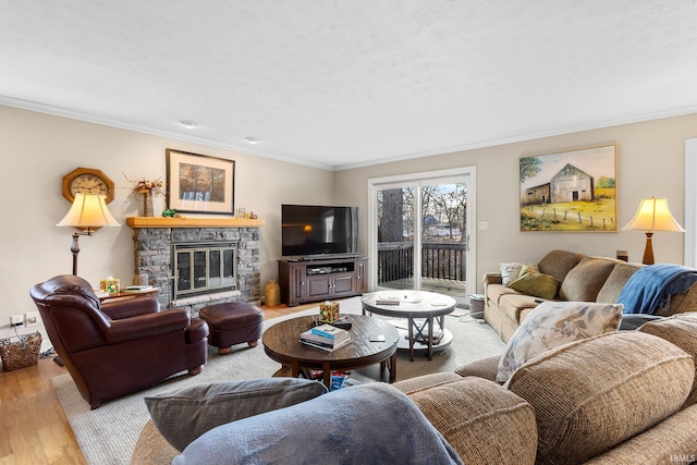 living room featuring crown molding, a fireplace, and light wood-type flooring