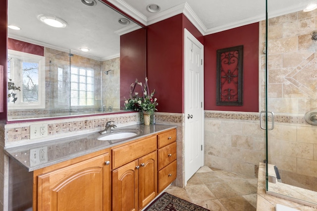 bathroom featuring ornamental molding, tile walls, vanity, and walk in shower