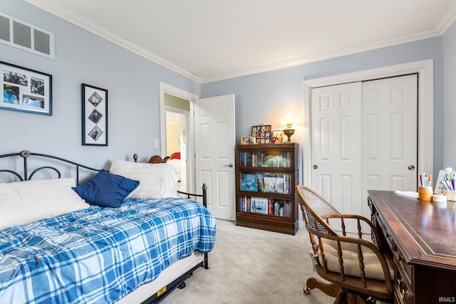 bedroom featuring ornamental molding, carpet flooring, and a closet