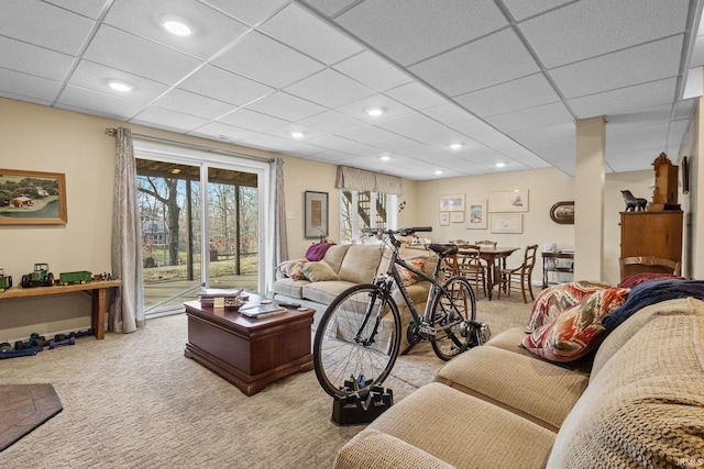 carpeted living room with a drop ceiling