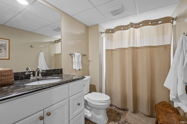 bathroom featuring vanity, a paneled ceiling, and toilet