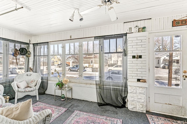 sunroom featuring ceiling fan and a wealth of natural light