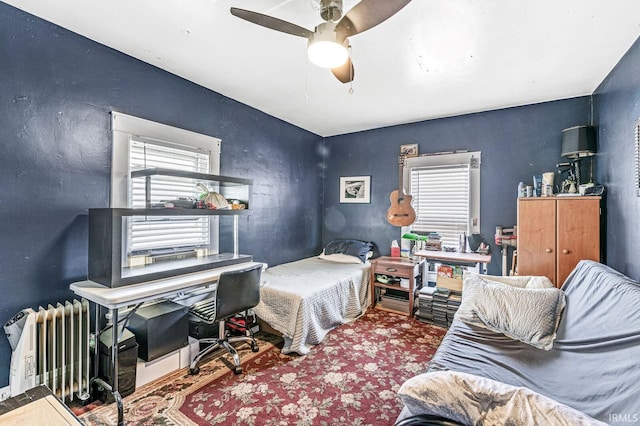 bedroom with radiator heating unit and ceiling fan