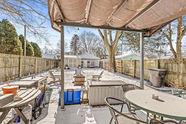 snow covered patio with an outbuilding