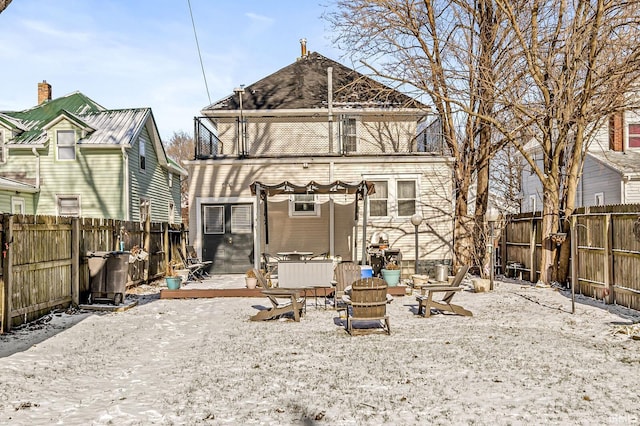 back of house with a fire pit