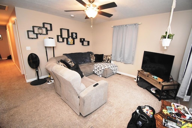 carpeted living room with ceiling fan