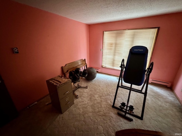 workout room with light carpet, a baseboard heating unit, and a textured ceiling