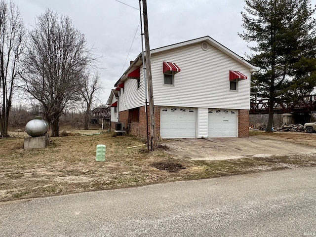 view of side of property with central AC and a garage