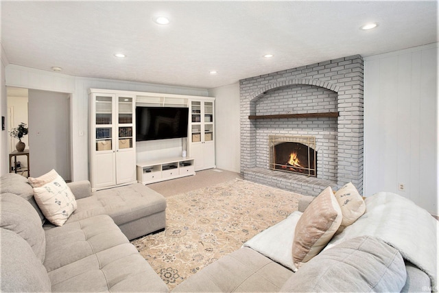 carpeted living room with a brick fireplace