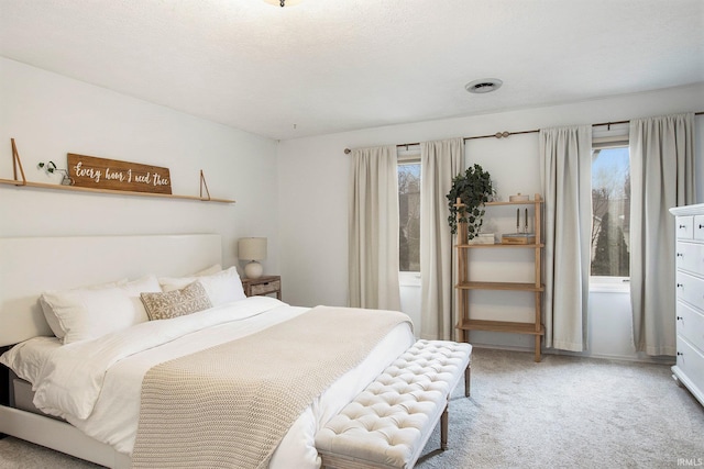 bedroom featuring a textured ceiling and carpet flooring