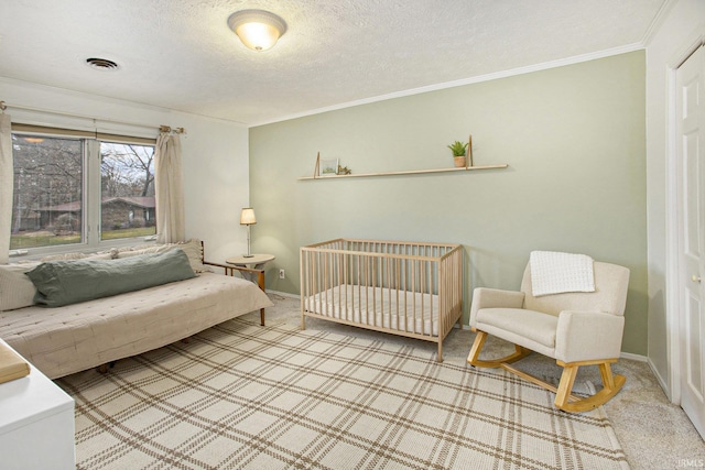 bedroom with crown molding, light colored carpet, and a textured ceiling