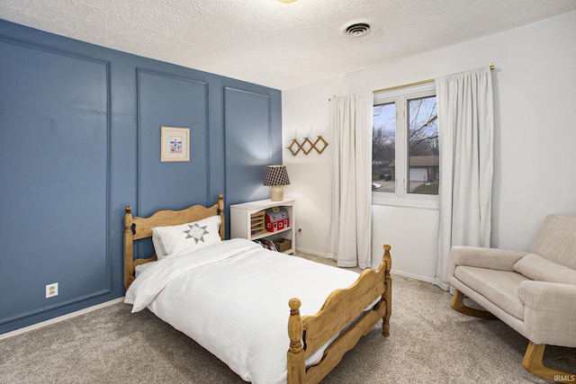 carpeted bedroom featuring a textured ceiling