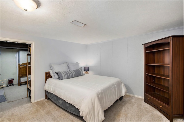 carpeted bedroom featuring a textured ceiling