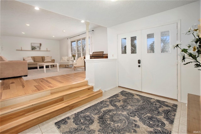 tiled foyer entrance featuring a textured ceiling and french doors