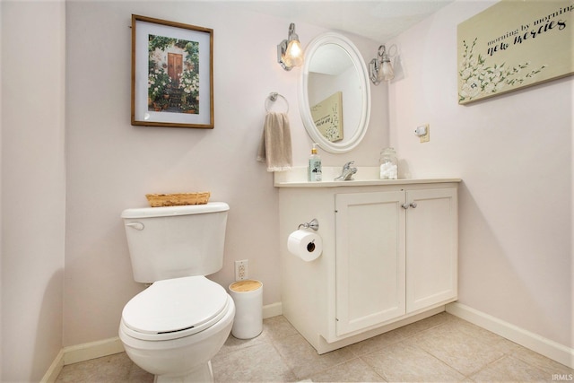 bathroom featuring vanity, tile patterned floors, and toilet