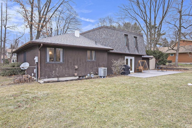 back of property featuring a yard, cooling unit, and a patio area