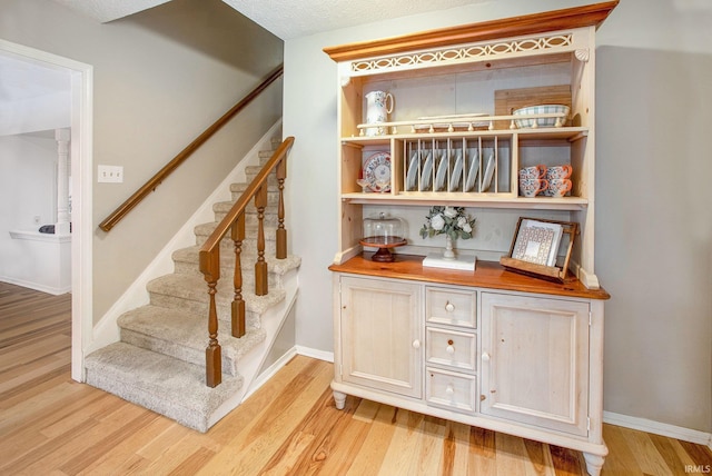 stairs with hardwood / wood-style flooring