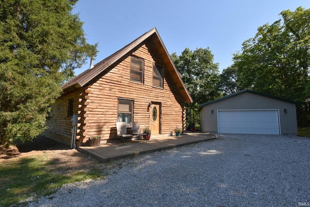 log home with an outbuilding and a garage