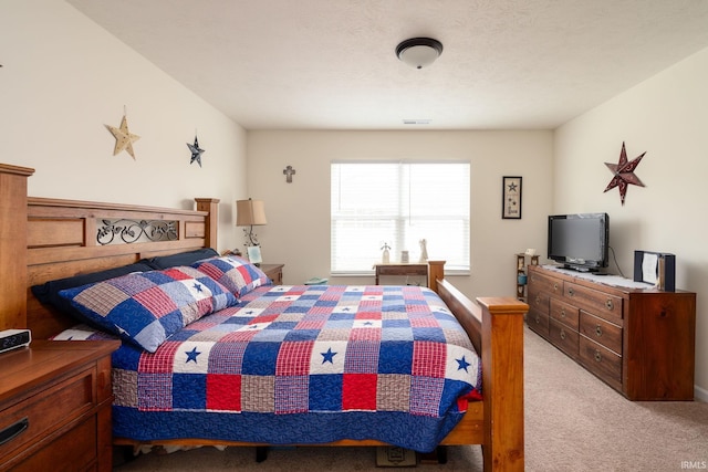 bedroom featuring light carpet