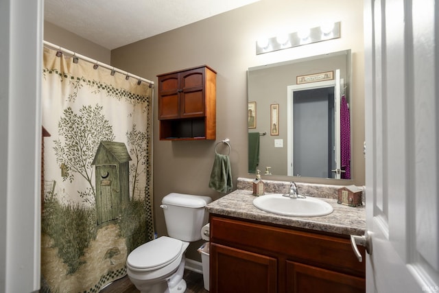 bathroom with a shower with curtain, vanity, and toilet