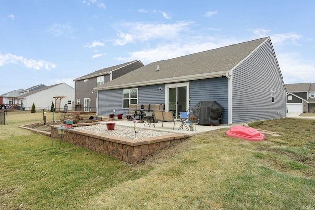 back of property with a lawn and a patio