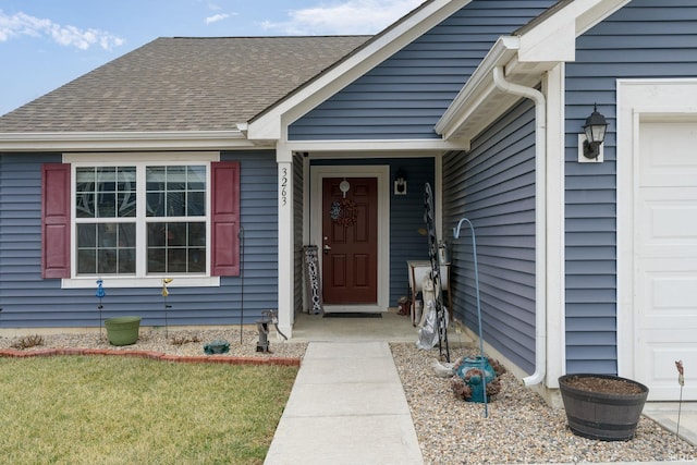 doorway to property with a garage