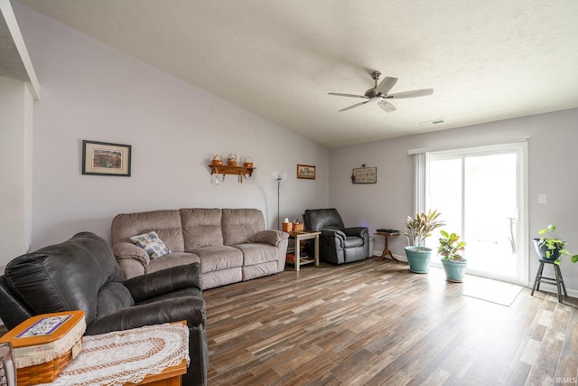 living room featuring hardwood / wood-style floors, a textured ceiling, vaulted ceiling, and ceiling fan