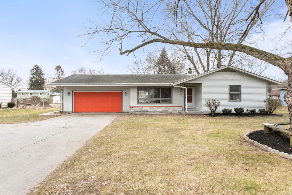 ranch-style home with a garage and a front yard