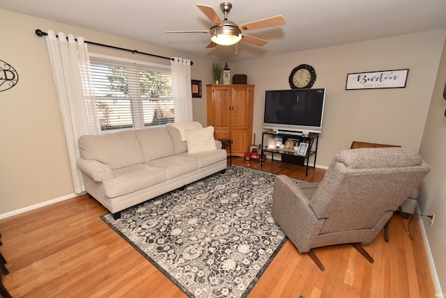 living room with wood-type flooring and ceiling fan