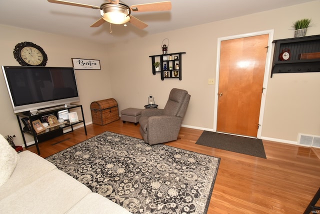 living room with hardwood / wood-style flooring and ceiling fan