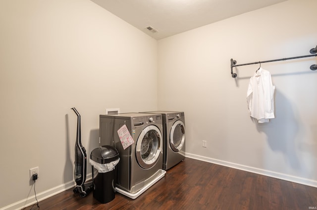 clothes washing area featuring separate washer and dryer and dark hardwood / wood-style floors