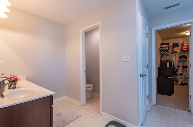 bathroom with vanity and toilet