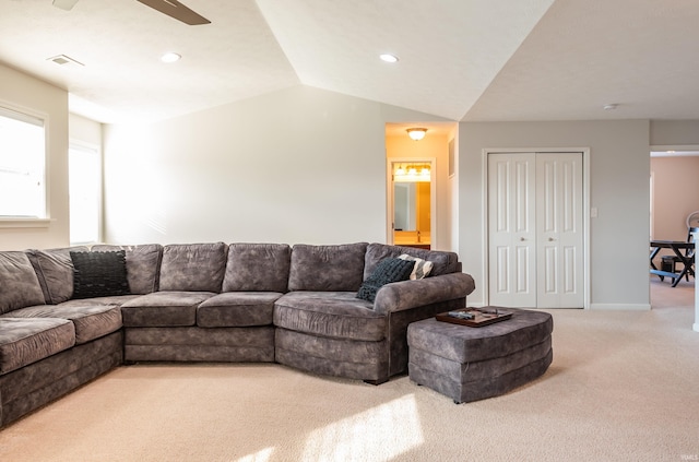 carpeted living room with vaulted ceiling and ceiling fan