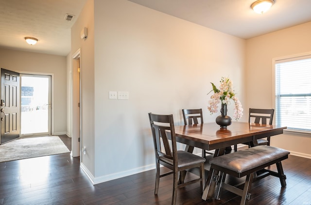 dining space with dark hardwood / wood-style flooring