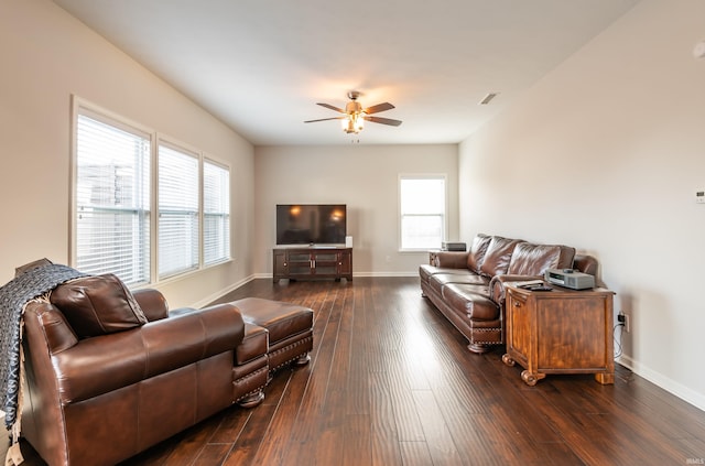 living room featuring dark hardwood / wood-style floors and ceiling fan