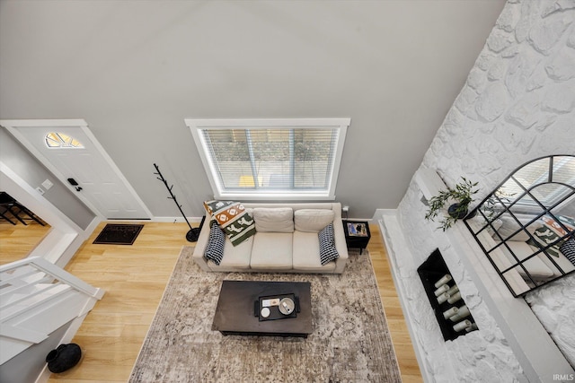 living room with wood-type flooring and high vaulted ceiling