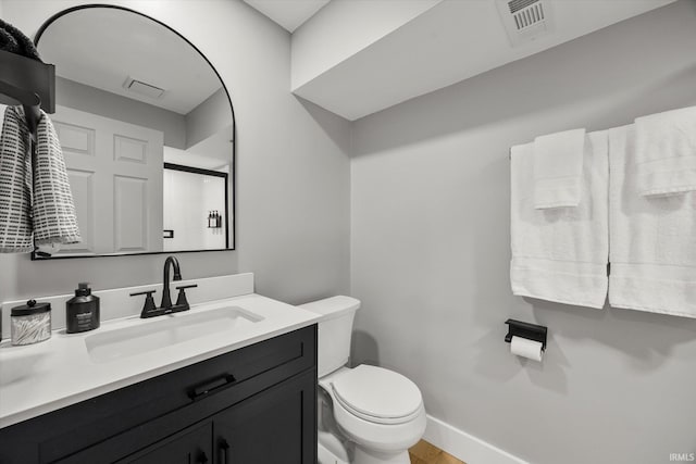 bathroom featuring vanity and toilet