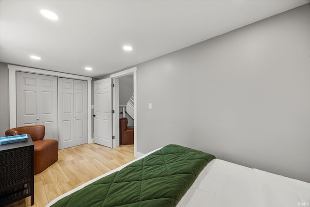 bedroom with hardwood / wood-style floors and a closet