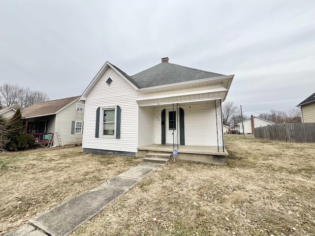 view of front of house featuring covered porch and a front yard