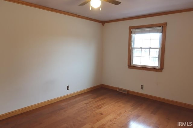 unfurnished room with ornamental molding, ceiling fan, and light wood-type flooring