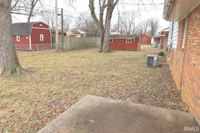 view of yard with a storage shed and central air condition unit